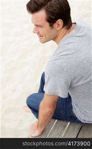 Portrait man sitting by beach