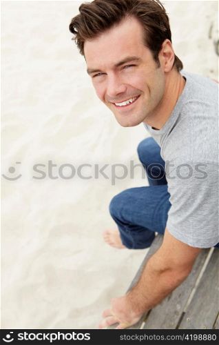 Portrait man sitting by beach