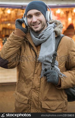 portrait man wearing winter ear muffs