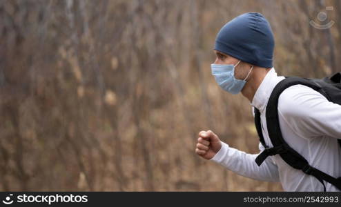 portrait man with face mask running woods