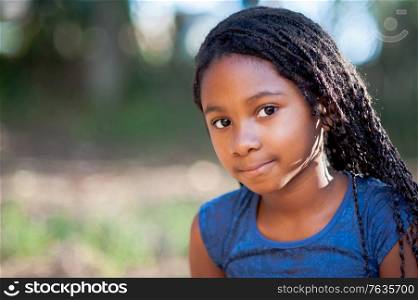 Portrait of a african girl in the nature looking at the camera