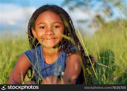 Portrait of a african girl in the nature looking at the camera
