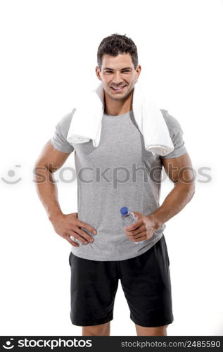 Portrait of a athletic man after doing exercises and holding a bottle of water, isolated over a white background