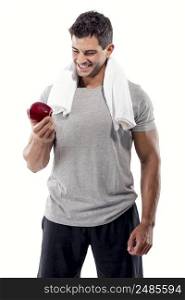 Portrait of a athletic man holding a fresh apple, isolated over a white background