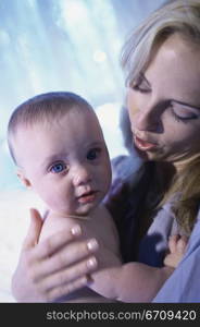 Portrait of a baby boy held by his mother