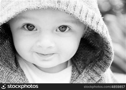 Portrait of a baby in a hood
