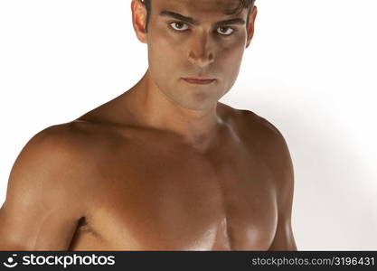 Portrait of a bare chested young man looking serious