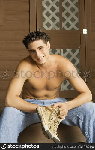 Portrait of a bare chested young man smiling