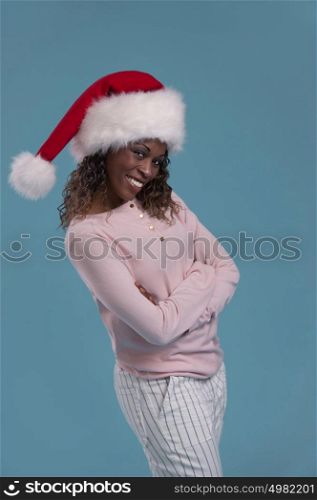 Portrait of a beautiful african woman wearing a santa hat smiling