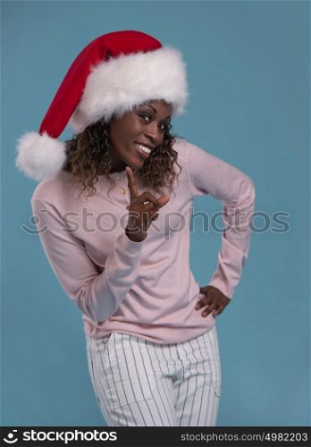 Portrait of a beautiful african woman wearing a santa hat smiling