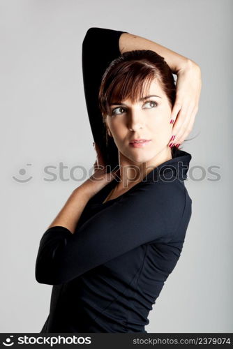 Portrait of a beautiful and fashion woman isolated over a gray background