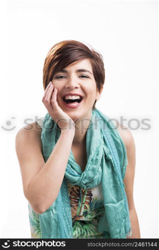 Portrait of a beautiful and happy woman laughing with a modern hair cut, isolated on white background