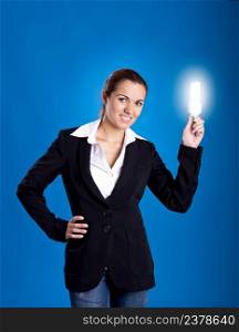 Portrait of a beautiful and young businesswoman holding a lightbulb