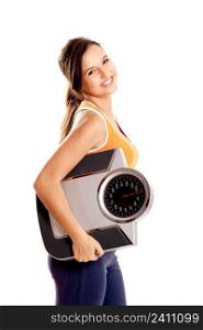 Portrait of a beautiful athletic girl holding a scale, isolated on white