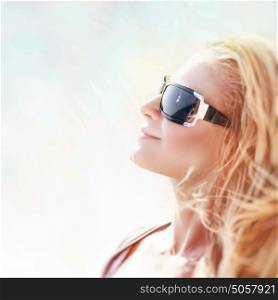 Portrait of a beautiful blond woman on sunny day, wearing stylish sunglasses, female enjoying summertime, happy summer holidays