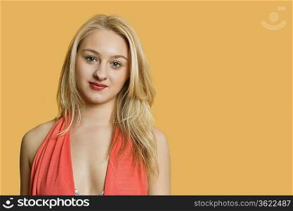 Portrait of a beautiful blond woman over colored background