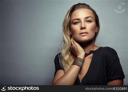 Portrait of a beautiful blond woman over gray background, gorgeous model with natural makeup, photo with copy space, beauty and fashion concept