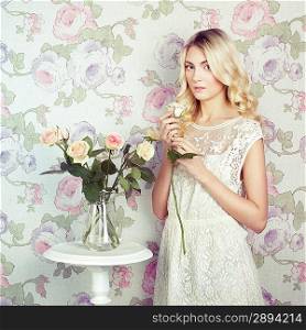 Portrait of a beautiful blonde woman with flowers. Fashion photo