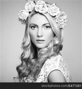 Portrait of a beautiful blonde woman with flowers in her hair. Portrait of a beautiful blonde woman with flowers in her hair. Fashion photo