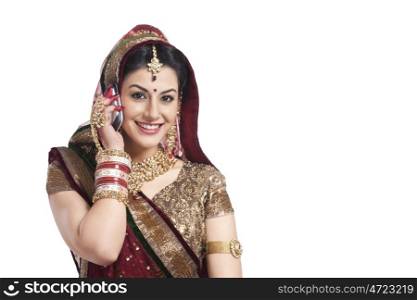Portrait of a beautiful bride talking on a mobile phone