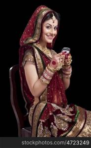 Portrait of a beautiful bride with a mobile phone