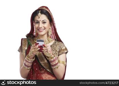 Portrait of a beautiful bride with mobile phone