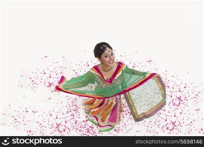 Portrait of a beautiful bride with rose petals smiling