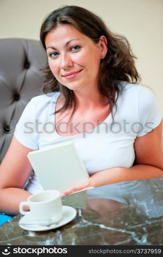 portrait of a beautiful brunette in a chair at the table