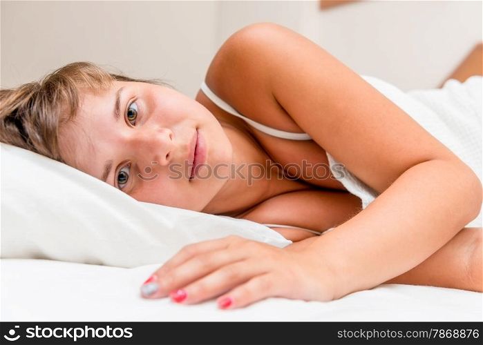 portrait of a beautiful brunette in bed before bedtime