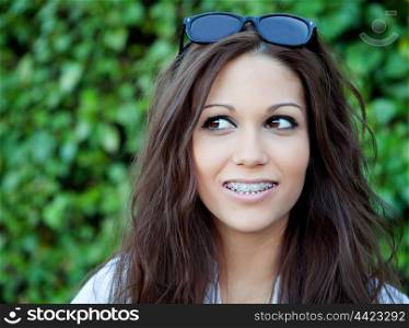 Portrait of a beautiful brunette outdoors in the park thinking
