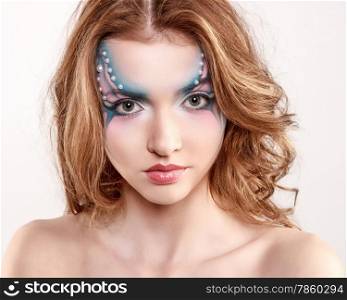 Portrait of a beautiful brunette woman in carnival makeup
