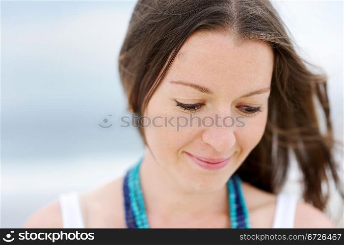Portrait of a beautiful brunette woman with a necklace