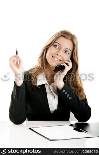 Portrait of a beautiful business woman in the office using a cellphone