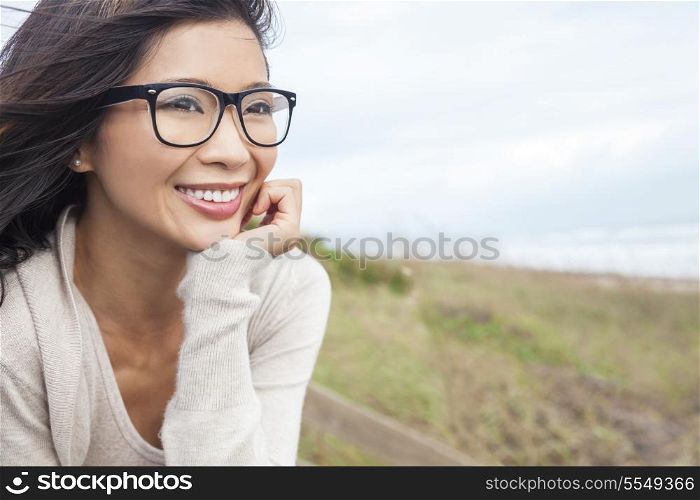 Portrait of a beautiful chinese asian girl or young woman outside wearing glasses