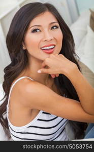 Portrait of a beautiful Chinese Asian young woman or girl smiling with perfect teeth