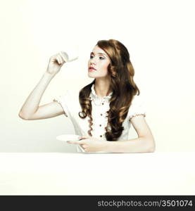 Portrait of a beautiful elegant lady at white table