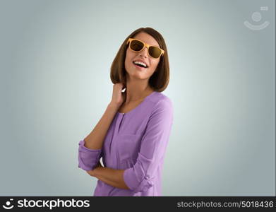 Portrait of a beautiful fashion girl with sunglasses expressing positivity