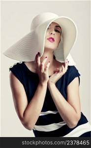 Portrait of a beautiful fashion woman posing with a hat
