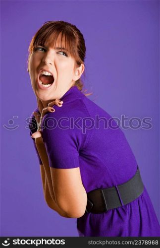 Portrait of a beautiful fashion yelling, over a violet background