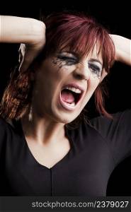 Portrait of a Beautiful fashion young woman yelling over a black background