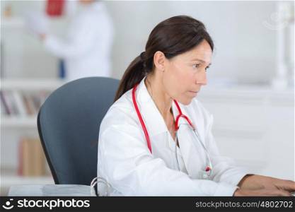 portrait of a beautiful female doctor working in her office