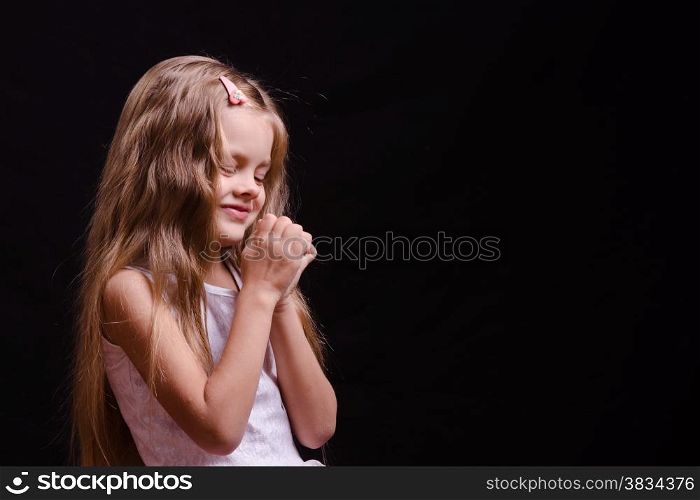 Portrait of a beautiful five year old girl on a black background