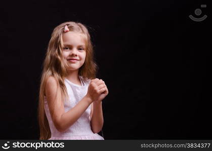 Portrait of a beautiful five year old girl on a black background