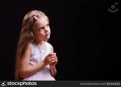Portrait of a beautiful five year old girl on a black background