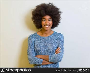 portrait of a beautiful friendly African American woman with a curly afro hairstyle and lovely smile isolated on a white background