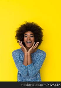 portrait of a beautiful friendly African American woman with a curly afro hairstyle and lovely smile isolated on a Yellow background