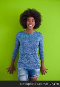 portrait of a beautiful friendly African American woman with a curly afro hairstyle and lovely smile isolated on a Green background