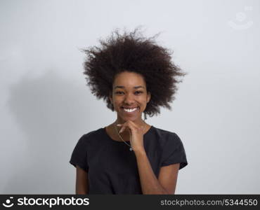 portrait of a beautiful friendly African American woman with a curly afro hairstyle and lovely smile isolated on a white background