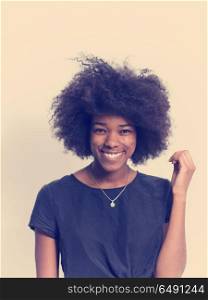 portrait of a beautiful friendly African American woman with a curly afro hairstyle and lovely smile isolated on a white background. black woman isolated on a white background