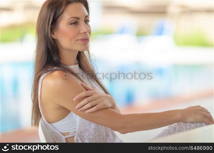Portrait of a beautiful gentle woman on beach resort, authentic genuine beauty of young female, peaceful summer vacation. Gentle woman on beach resort